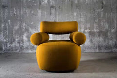 The Amalfi Chair redefines statement seating with its architectural silhouette and sculptural presence. Cylindrical arm bolsters and a contoured backrest create a harmonious balance between form and function, while the generous seat invites lingering moments of comfort.