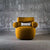 The Amalfi Chair redefines statement seating with its architectural silhouette and sculptural presence. Cylindrical arm bolsters and a contoured backrest create a harmonious balance between form and function, while the generous seat invites lingering moments of comfort.