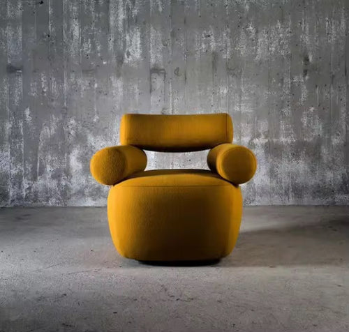 The Amalfi Chair redefines statement seating with its architectural silhouette and sculptural presence. Cylindrical arm bolsters and a contoured backrest create a harmonious balance between form and function, while the generous seat invites lingering moments of comfort.