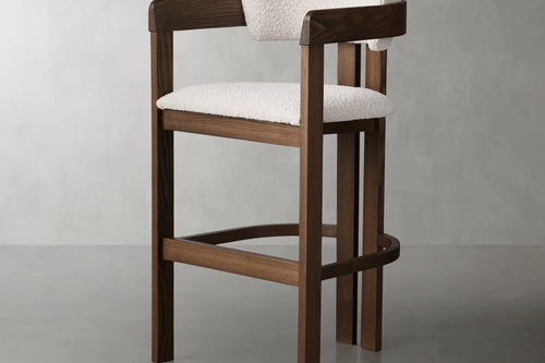 The Obelisk Chair is a celebration of geometry and structure—crafted with precision to bring architectural poise into everyday living. Its strong wooden frame and sculpted backrest create a grounded silhouette, while the bouclé upholstered seat and back add a tactile softness, balancing strength with comfort.