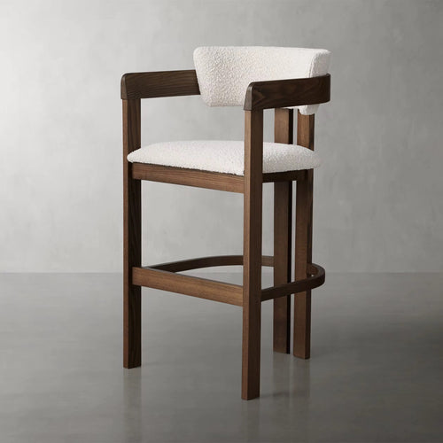 The Obelisk Chair is a celebration of geometry and structure—crafted with precision to bring architectural poise into everyday living. Its strong wooden frame and sculpted backrest create a grounded silhouette, while the bouclé upholstered seat and back add a tactile softness, balancing strength with comfort.