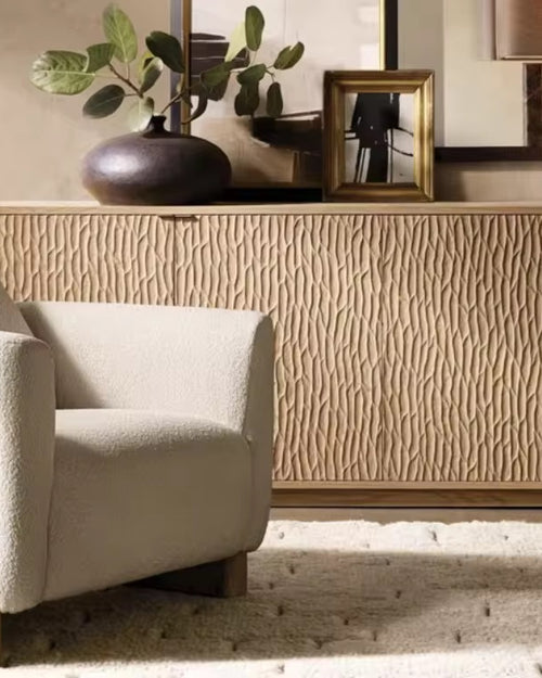 The Rune Chair brings together sculptural design and grounded elegance. Its bold silhouette is softened by plush upholstery, while the solid wooden block legs anchor the piece with a sense of stability and strength. Minimal yet striking, it’s a chair that blends comfort with architectural beauty.