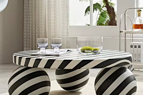 The Axis Table is a statement piece that redefines modern living. With its 3ft diameter surface and sculptural sphere legs, this table blends bold artistry with everyday function. Its striking black-and-white striped design adds a playful yet sophisticated touch, making it as much a conversation starter as it is a functional centerpiece.