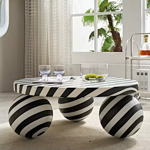 The Axis Table is a statement piece that redefines modern living. With its 3ft diameter surface and sculptural sphere legs, this table blends bold artistry with everyday function. Its striking black-and-white striped design adds a playful yet sophisticated touch, making it as much a conversation starter as it is a functional centerpiece.