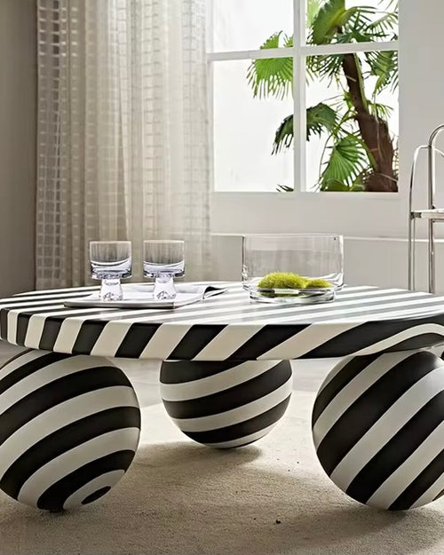 The Axis Table is a statement piece that redefines modern living. With its 3ft diameter surface and sculptural sphere legs, this table blends bold artistry with everyday function. Its striking black-and-white striped design adds a playful yet sophisticated touch, making it as much a conversation starter as it is a functional centerpiece.