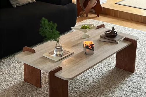 The Akira Table embodies refined modern design with a touch of natural beauty. Featuring a marble travertine top paired with teak wood legs, it offers a harmonious blend of textures and tones. The clean lines and sculptural form create a striking yet understated presence, making it the perfect centerpiece for contemporary living spaces.