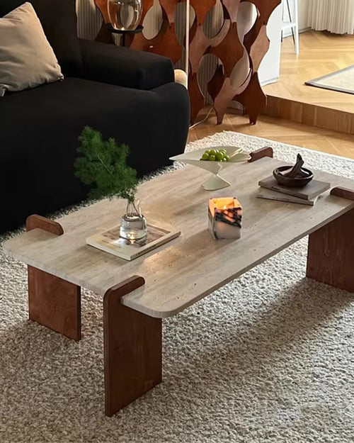 The Akira Table embodies refined modern design with a touch of natural beauty. Featuring a marble travertine top paired with teak wood legs, it offers a harmonious blend of textures and tones. The clean lines and sculptural form create a striking yet understated presence, making it the perfect centerpiece for contemporary living spaces.