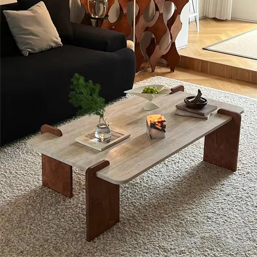 The Akira Table embodies refined modern design with a touch of natural beauty. Featuring a marble travertine top paired with teak wood legs, it offers a harmonious blend of textures and tones. The clean lines and sculptural form create a striking yet understated presence, making it the perfect centerpiece for contemporary living spaces.