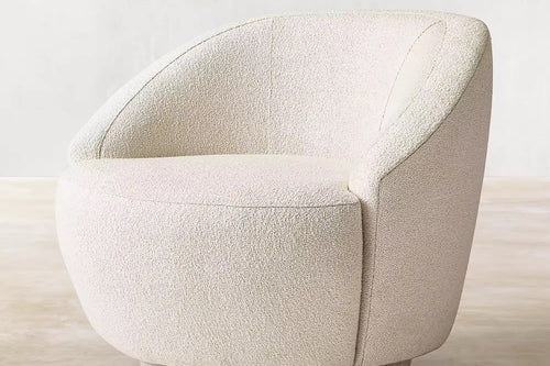 The Kingston Chair is the perfect blend of comfort and modern design. Featuring a 360° swivel base and wrapped in luxurious boucle upholstery, it offers both functionality and timeless style. Its curved silhouette, soft texture, and smooth motion make it an inviting centerpiece for living rooms, reading corners, or lounges. Luxury furniture by chair collective. 