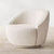 The Kingston Chair is the perfect blend of comfort and modern design. Featuring a 360° swivel base and wrapped in luxurious boucle upholstery, it offers both functionality and timeless style. Its curved silhouette, soft texture, and smooth motion make it an inviting centerpiece for living rooms, reading corners, or lounges. Luxury furniture by chair collective. 