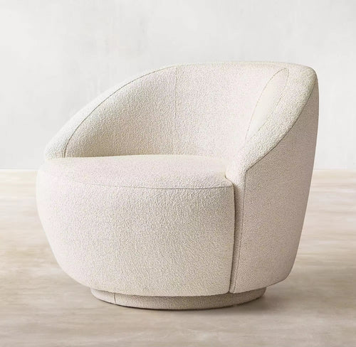 The Kingston Chair is the perfect blend of comfort and modern design. Featuring a 360° swivel base and wrapped in luxurious boucle upholstery, it offers both functionality and timeless style. Its curved silhouette, soft texture, and smooth motion make it an inviting centerpiece for living rooms, reading corners, or lounges. Luxury furniture by chair collective. 