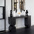 The Noir Console is a striking fusion of contemporary design and sculptural artistry. Crafted with clean lines and bold geometric shapes, it features a deep matte black finish that adds drama and sophistication to any interior. Its sleek form and strong presence make it a perfect statement piece for entryways, living rooms, or hallways where modern elegance and functional style are key.