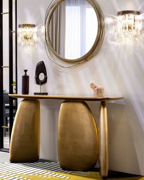 The Aurum Console is a statement piece that effortlessly blends modern elegance with artistic form. Crafted from premium metal and finished with exquisite gold foiling, it brings a touch of opulence and sophistication to any interior. Its sculptural silhouette and bold curves create a striking focal point, perfect for enhancing entryways, living rooms, or sophisticated lounge areas.
