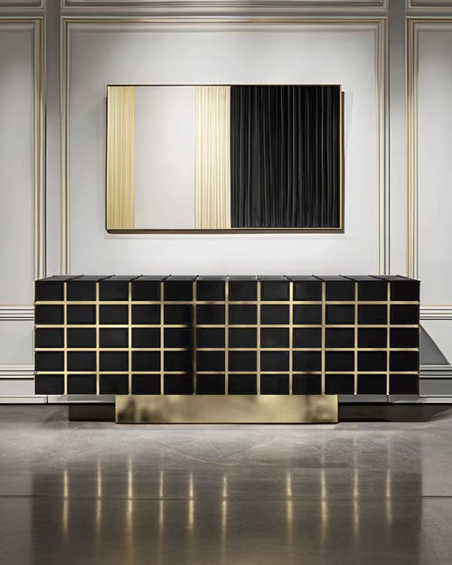 The Marbella Console is a striking fusion of modern design and opulent finishes. Featuring sleek black surfaces with golden accents, this console adds depth and sophistication to any interior. Its geometric pattern is elevated with polished golden lines that bring an architectural elegance to the piece, while the spacious storage compartments inside ensure practicality without compromising on style. Crafted for upscale living spaces, Marbella is perfect for adding a refined touch to living rooms, dining are