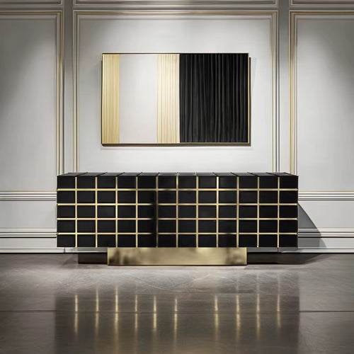 The Marbella Console is a striking fusion of modern design and opulent finishes. Featuring sleek black surfaces with golden accents, this console adds depth and sophistication to any interior. Its geometric pattern is elevated with polished golden lines that bring an architectural elegance to the piece, while the spacious storage compartments inside ensure practicality without compromising on style. Crafted for upscale living spaces, Marbella is perfect for adding a refined touch to living rooms, dining are