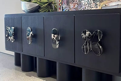Discover the Clayton Console – luxury console furniture online in India. 7 ft veneer design with Selenite marble inlays and teak wood ball legs.