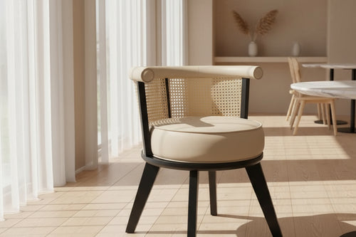 Discover the Jaypore Cafe Chair Online – an ultimate luxury piece with a dark wood frame, elegant cane back, rolled upholstered top rail, and a plush round seat.

