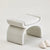 Minimalist accent pouf with unique fluid structure