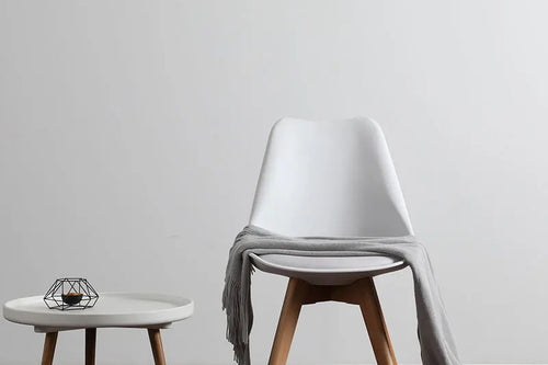 Modern cafe chair with a white plastic top 