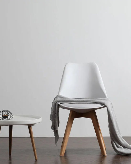 Modern cafe chair with a white plastic top 