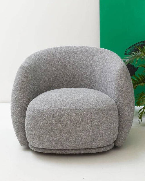 A gray oversized, round bucket chair with plush cushioning