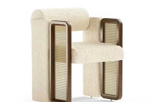 Kavish Dining Chair is a luxury designer dining chair with plush upholstery and rattan side detailing, perfect for modern dining rooms, café seating, and premium interiors.