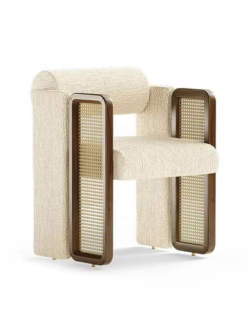 Kavish Dining Chair is a luxury designer dining chair with plush upholstery and rattan side detailing, perfect for modern dining rooms, café seating, and premium interiors.