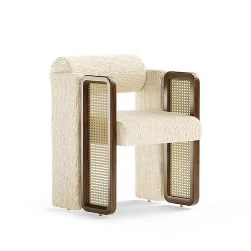 Kavish Dining Chair is a luxury designer dining chair with plush upholstery and rattan side detailing, perfect for modern dining rooms, café seating, and premium interiors.