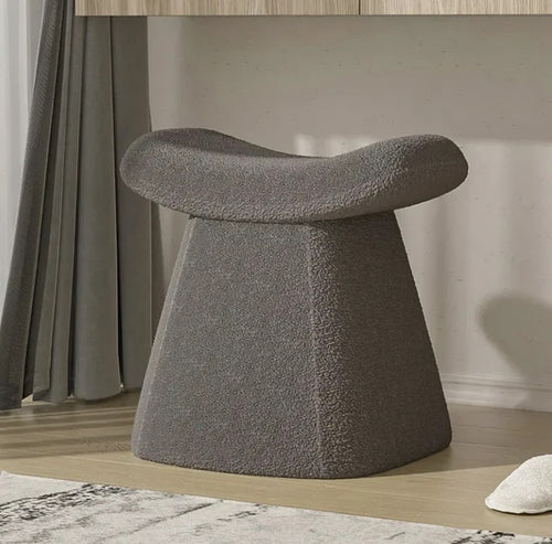 Curved grey pouf for modern interiors