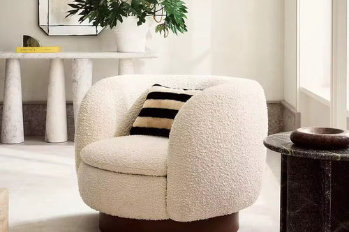 Labia Japandi Accent Chair in boucle with a rounded wooden base. A modern luxury accent chair offering comfort, warmth, and sculptural elegance.