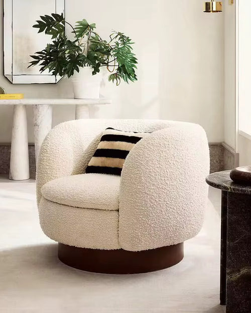 Labia Japandi Accent Chair in boucle with a rounded wooden base. A modern luxury accent chair offering comfort, warmth, and sculptural elegance.