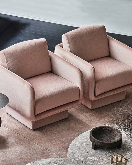 A pair of pink upholstered chairs with a modern design