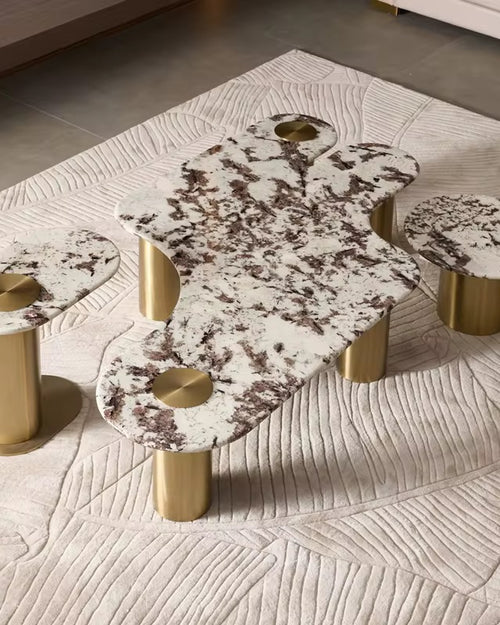 Shop the Luxero Luxury Coffee Table Set featuring an abstract marble top, elliptical and round end tables, and PVD-finished stainless steel bases. A perfect statement piece for modern luxury living rooms in India. Custom marble options available.