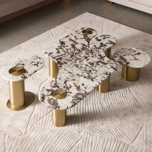 Shop the Luxero Luxury Coffee Table Set featuring an abstract marble top, elliptical and round end tables, and PVD-finished stainless steel bases. A perfect statement piece for modern luxury living rooms in India. Custom marble options available.