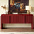 Bold red statement console featuring intricate fluted detailing, rounded edges, concealed storage, and a sculptural contemporary silhouette.