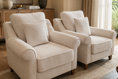 A luxurious upholstered accent chair featuring plush cushions, elegant rolled arms, a supportive backrest, and solid wooden legs designed for comfortable everyday living.