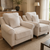 A luxurious upholstered accent chair featuring plush cushions, elegant rolled arms, a supportive backrest, and solid wooden legs designed for comfortable everyday living.