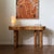 Sculptural Burno Foyer Console crafted in distinctive Mapa Burl with a natural finish, featuring an organic rounded silhouette and solid wooden legs for contemporary luxury interiors.