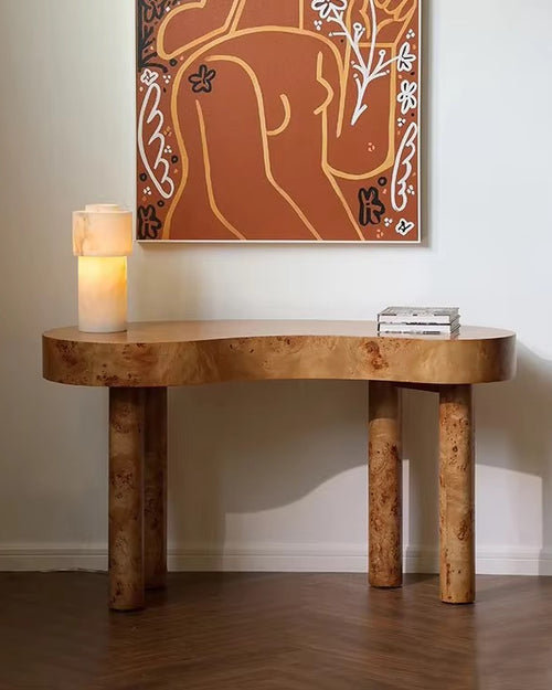 Sculptural Burno Foyer Console crafted in distinctive Mapa Burl with a natural finish, featuring an organic rounded silhouette and solid wooden legs for contemporary luxury interiors.