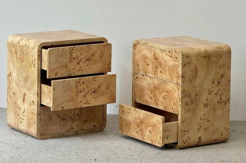 nightstands with three drawers each, featuring a distinctive light tan burl wood grain finish, shown on a light gray carpet against a plain wall.