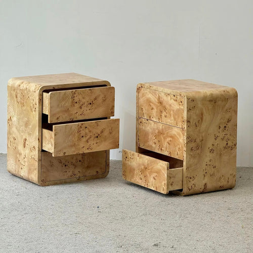  nightstands with three drawers each, featuring a distinctive light tan burl wood grain finish, shown on a light gray carpet against a plain wall.