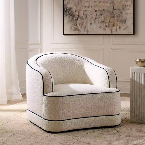 Modern upholstered accent chair featuring a sculptural curved silhouette, rounded arms, plush seating, and contrasting double piping detail.