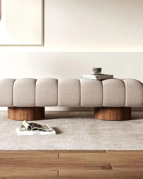 Front view of sculptural Arco Ottoman bench