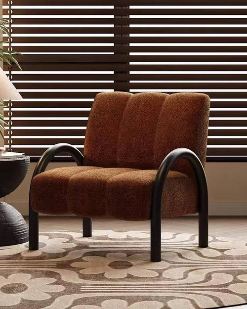 Brown cushioned chair with arched legs.