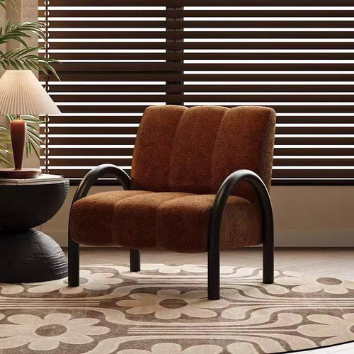 Brown cushioned chair with arched legs.