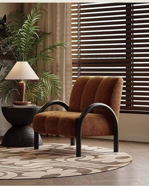 Brown lounge chair with black legs