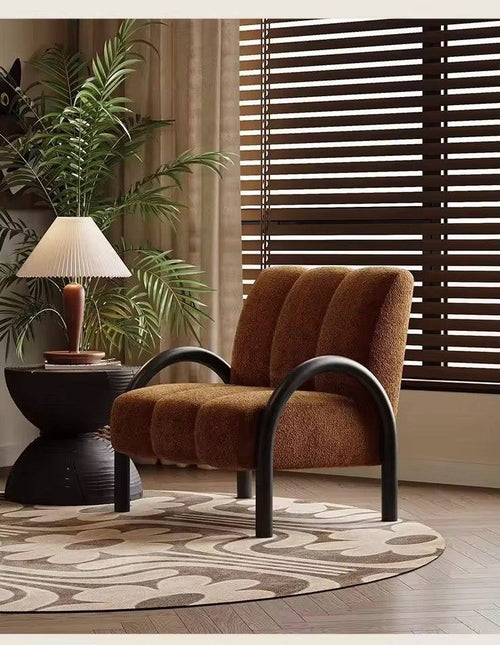 Brown lounge chair with black legs