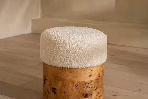 Discover the Mulatto Pouf, a modern luxury pouf with a soft cream bouclé seat and natural burl veneer base. Ideal for living rooms, vanity corners, and contemporary interiors. Buy premium designer poufs online in India.