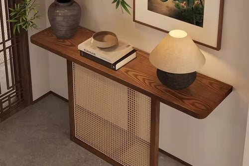The Opah Foyer Console is an elegant celebration of material harmony, where natural textures meet refined craftsmanship. Designed for homes that embrace warmth and restraint, this console features handwoven rattan detailing framed within a solid teak border, paired with a rich teak veneer top that adds depth and timeless character.