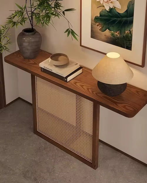 The Opah Foyer Console is an elegant celebration of material harmony, where natural textures meet refined craftsmanship. Designed for homes that embrace warmth and restraint, this console features handwoven rattan detailing framed within a solid teak border, paired with a rich teak veneer top that adds depth and timeless character.